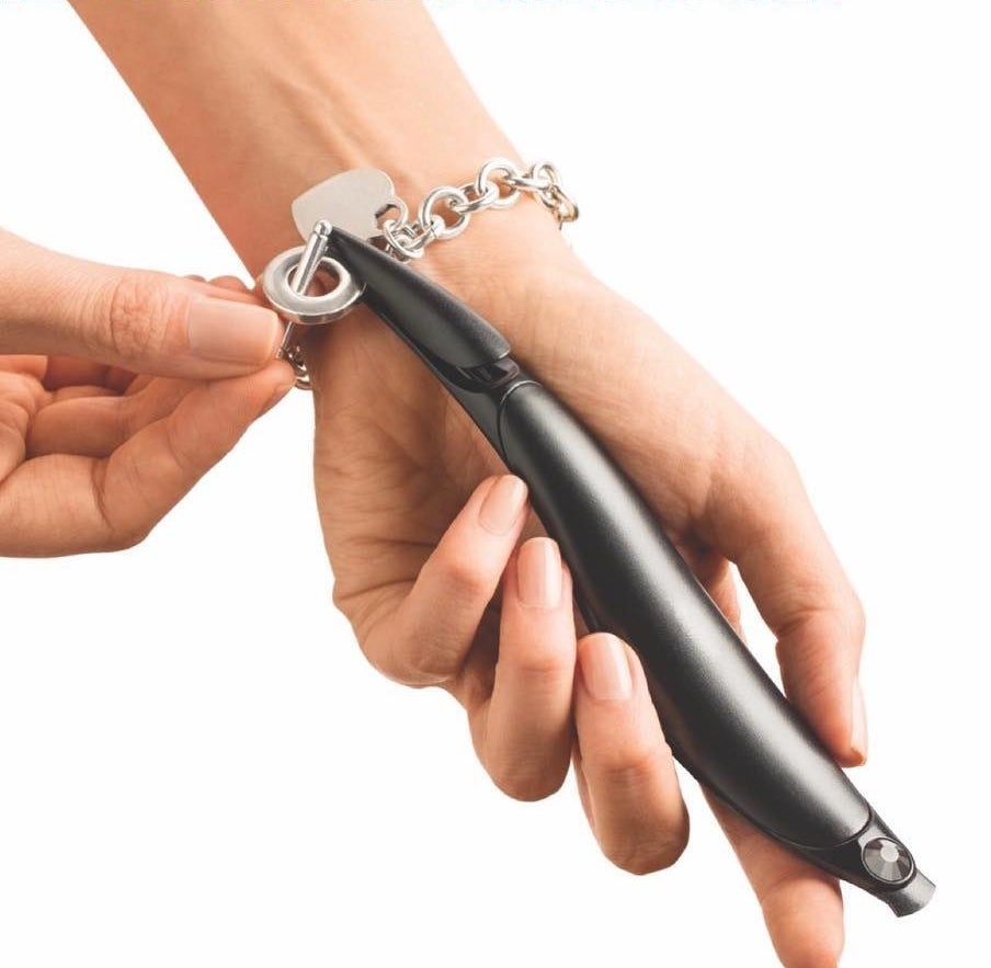 someone using the fastener to fasten their bracelet