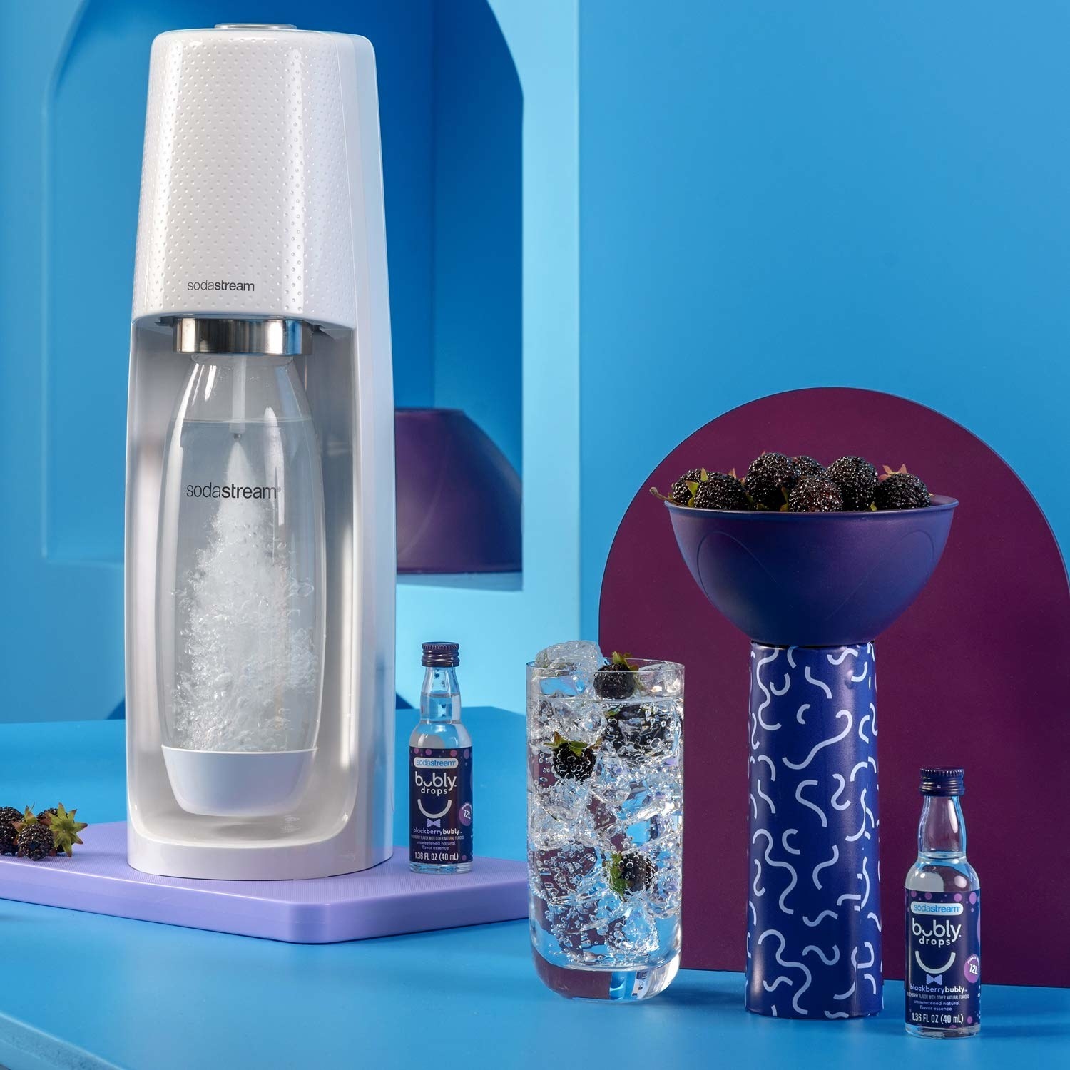 The SodaStream machine in a kitchen next to bottles of the Bubly drops