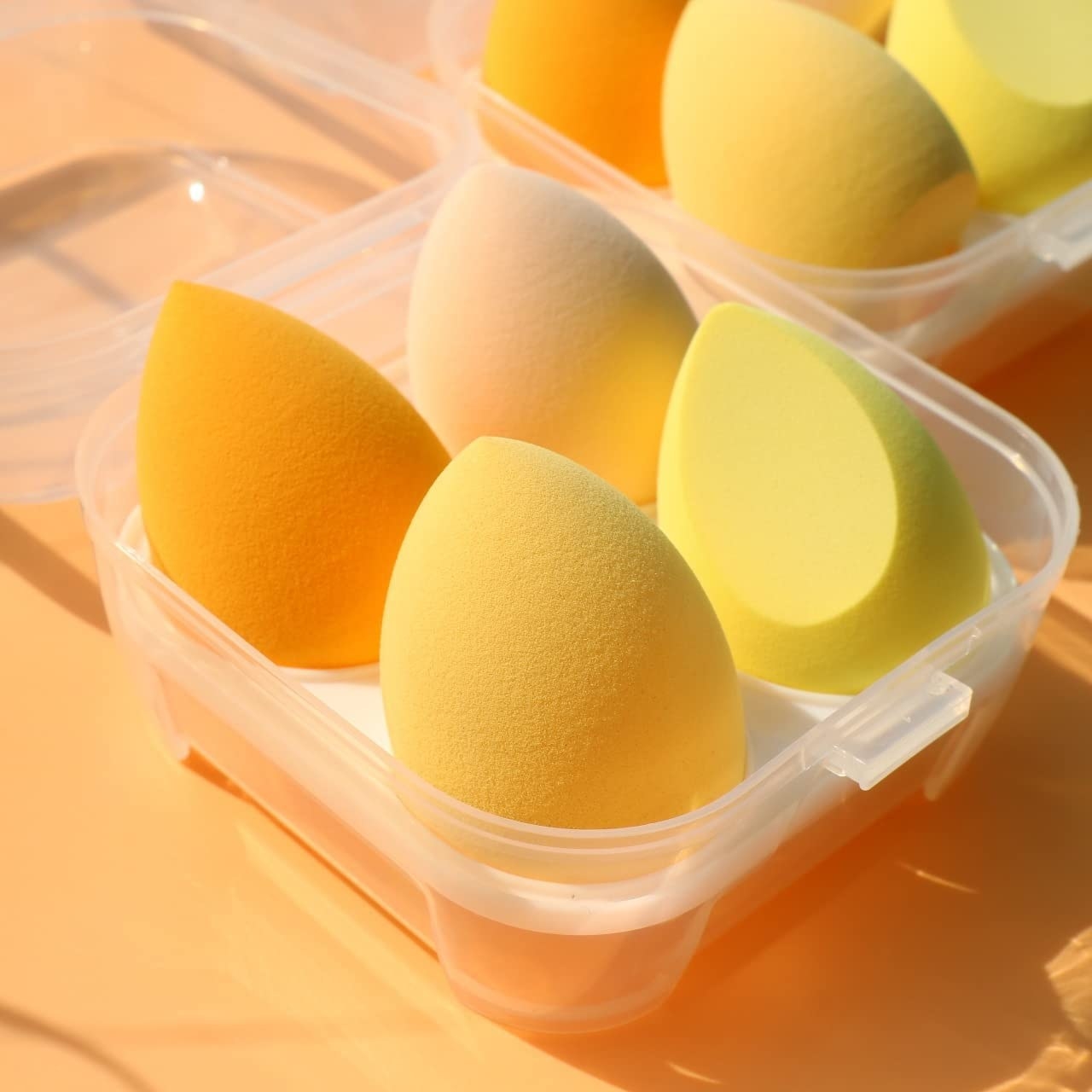 a set of makeup sponges inside a storage case shaped like an egg carton