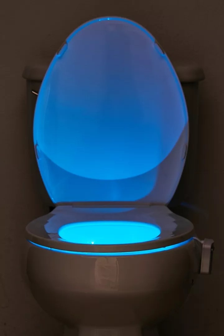 The toilet nightlight, lit up in the color blue