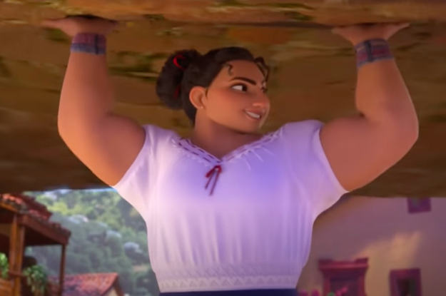 Luisa is lifting up a wooden table while smiling