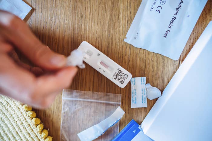 Hands performing a rapid antigen test