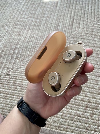 A pair of wireless earbuds in rose gold