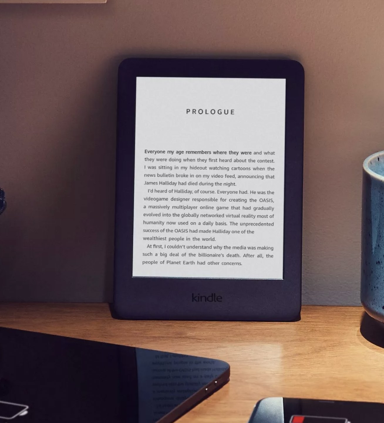 the e-reader on a desk displaying the first page of Ready Player One