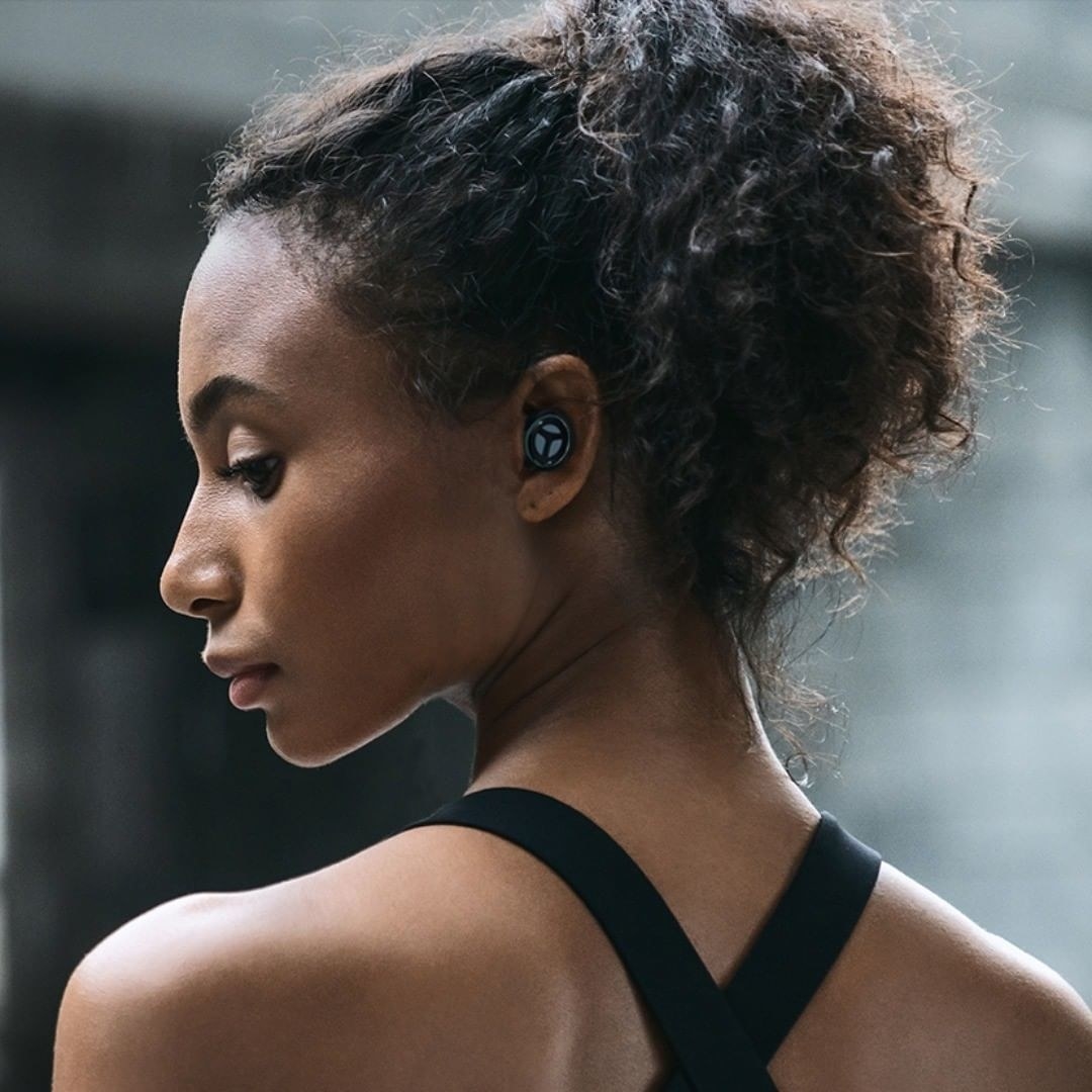 a side profile of a person wearing the petite ear buds
