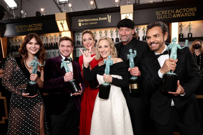 The cast of Coda poses with their awards