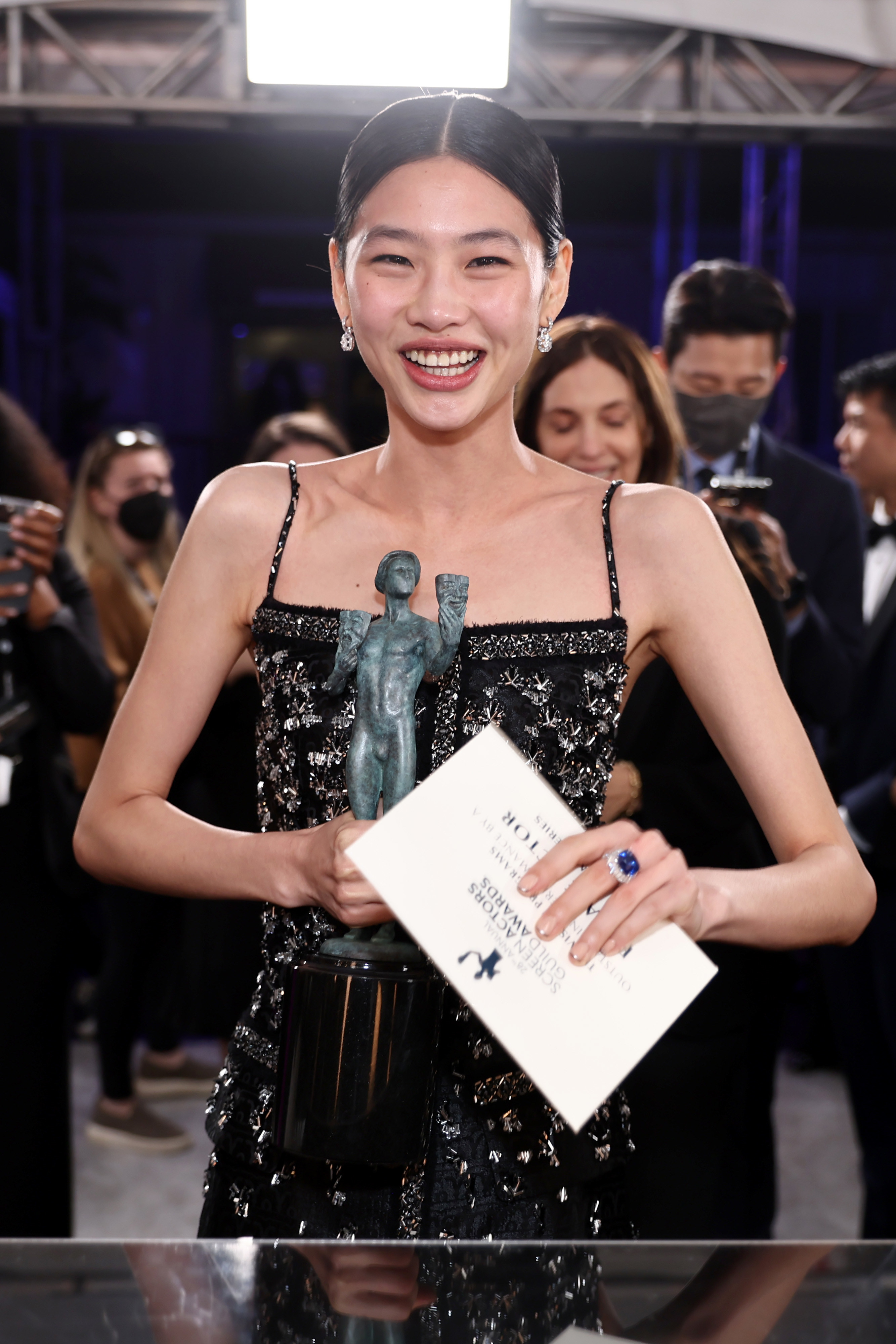 HoYeon Jung smiles while holding her award