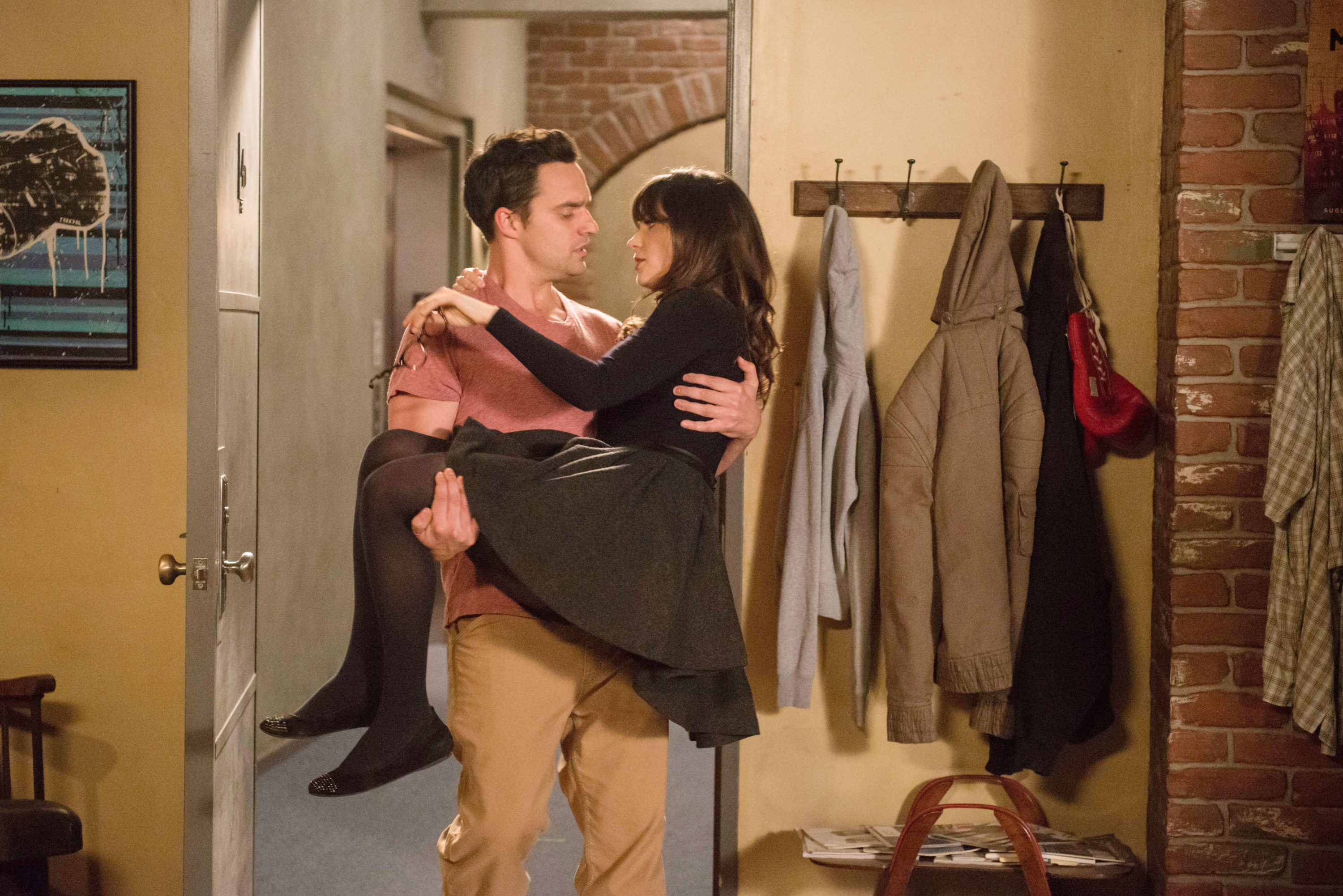 Nick carrying Jess into an apartment bridal style