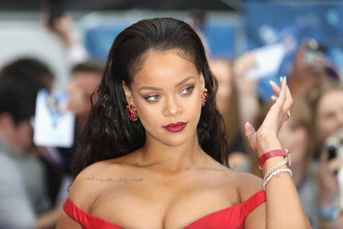 Rihanna poses for a photo at a red carpet event