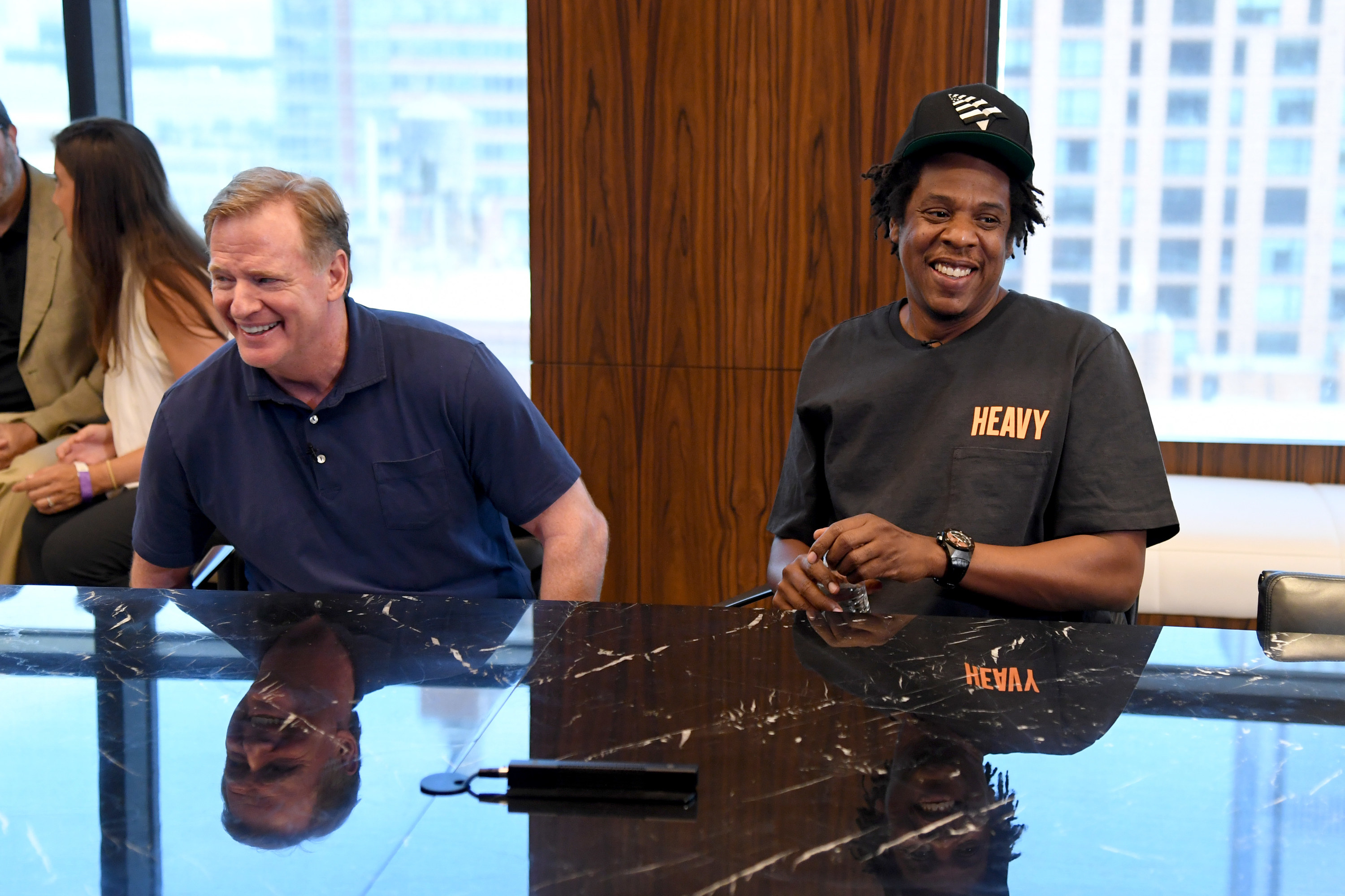 Roger Goodell and Jay-Z sitting down together announcing the partnership with the NFL and Roc Nation