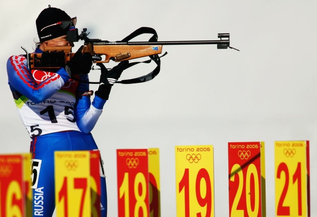A biathlon athlete firing their rifle