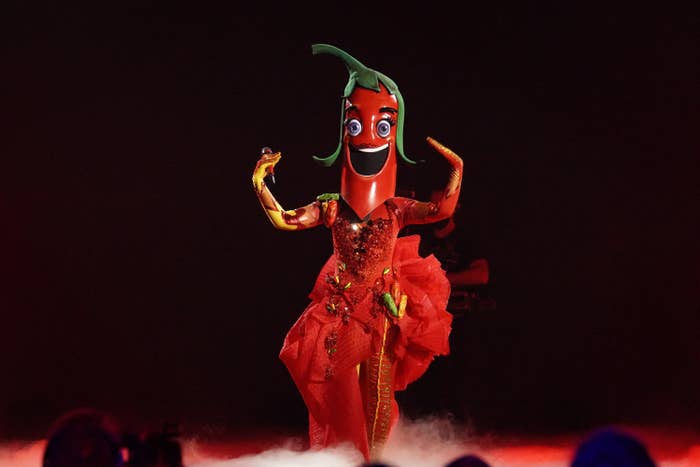 A contestant in a smiling chilli pepper costume