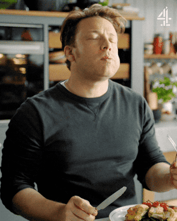 a gif of chef Jamie Oliver tasting a delicious meal