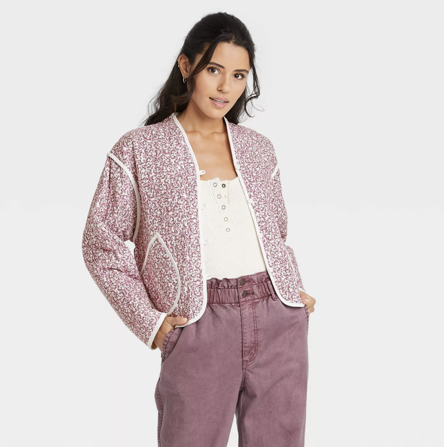 the quilted jacket in a pink and white flower pattern