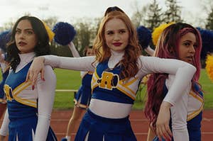 Cheryl Blossom leans her arms on the shoulders of Veronica Lodge and Toni Topaz