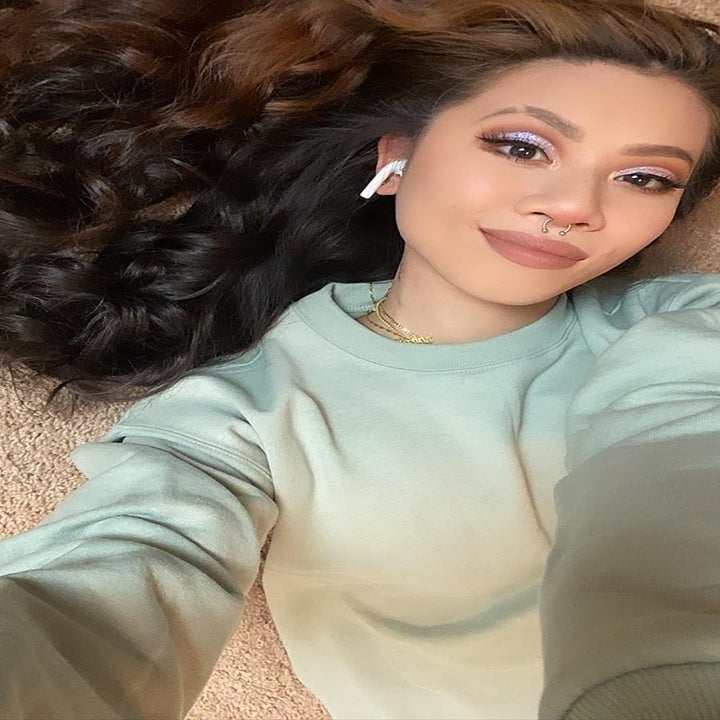 reviewer wearing the light green sweatshirt