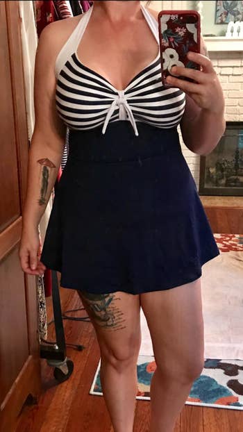 Reviewer photo of them wearing the navy and white striped swim dress