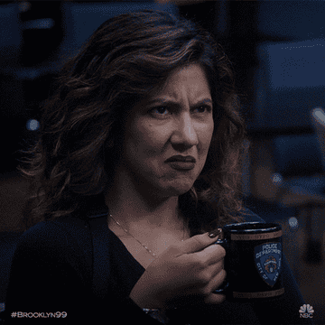 Rosa Diaz cringes and glares as she holds a mug of coffee on Brooklyn 99