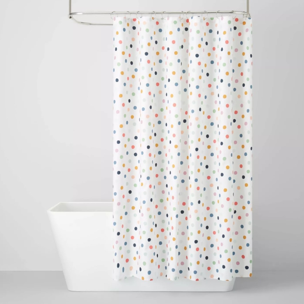 white shower curtain with polka dot design
