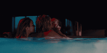 Three people kissing in the pool