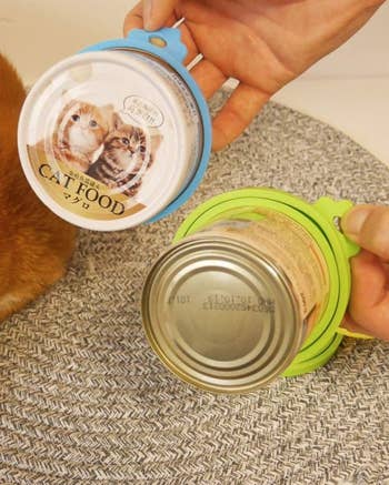 two different sized cans of cat food with the silicone lids on them