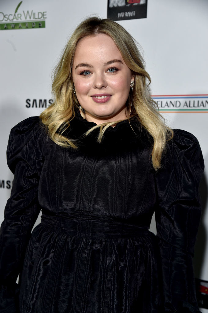 Nicola smiles at a red carpet event