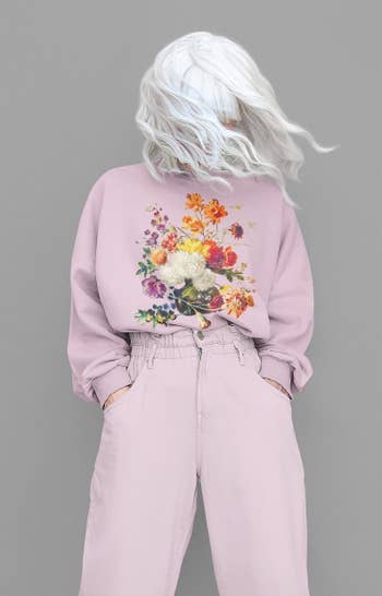 model wearing the purple floral sweatshirt