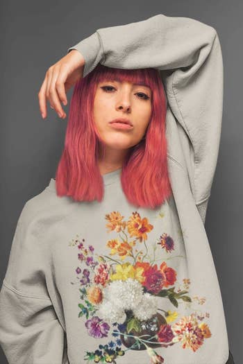 model wearing the gray floral sweatshirt