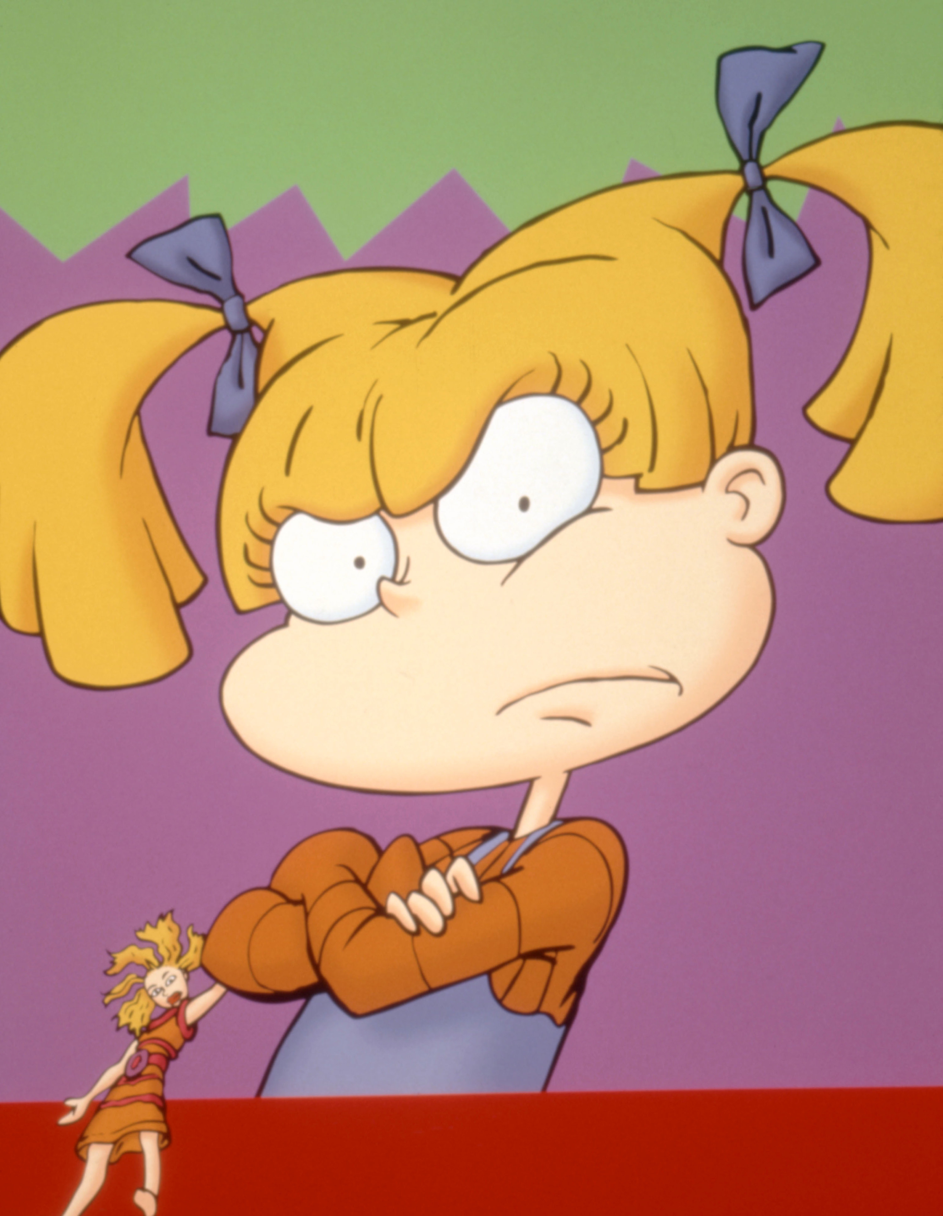 Angelica from Rugrats folding her arms and holding her Cynthia doll