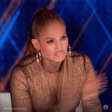 Jennifer Lopez standing up and clapping