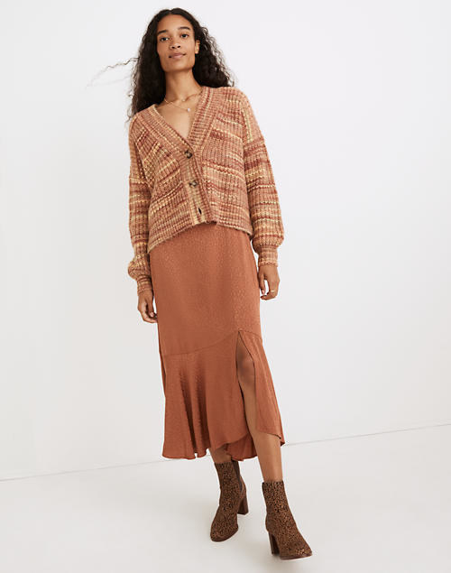 model wearing burnt orange midi skirt with brown boots