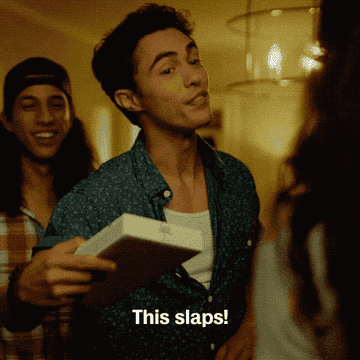 GIF of a kid at a party saying &quot;This slaps&quot;