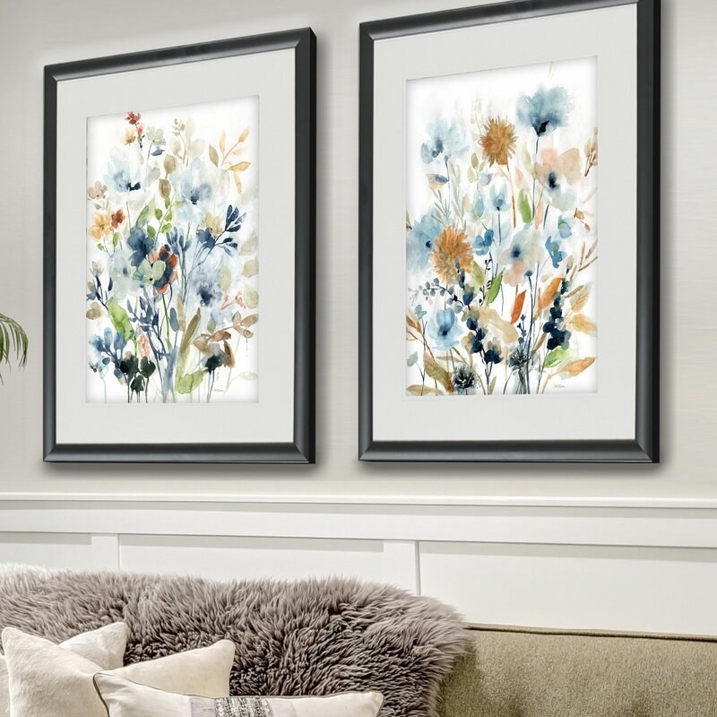 the two framed prints above a couch