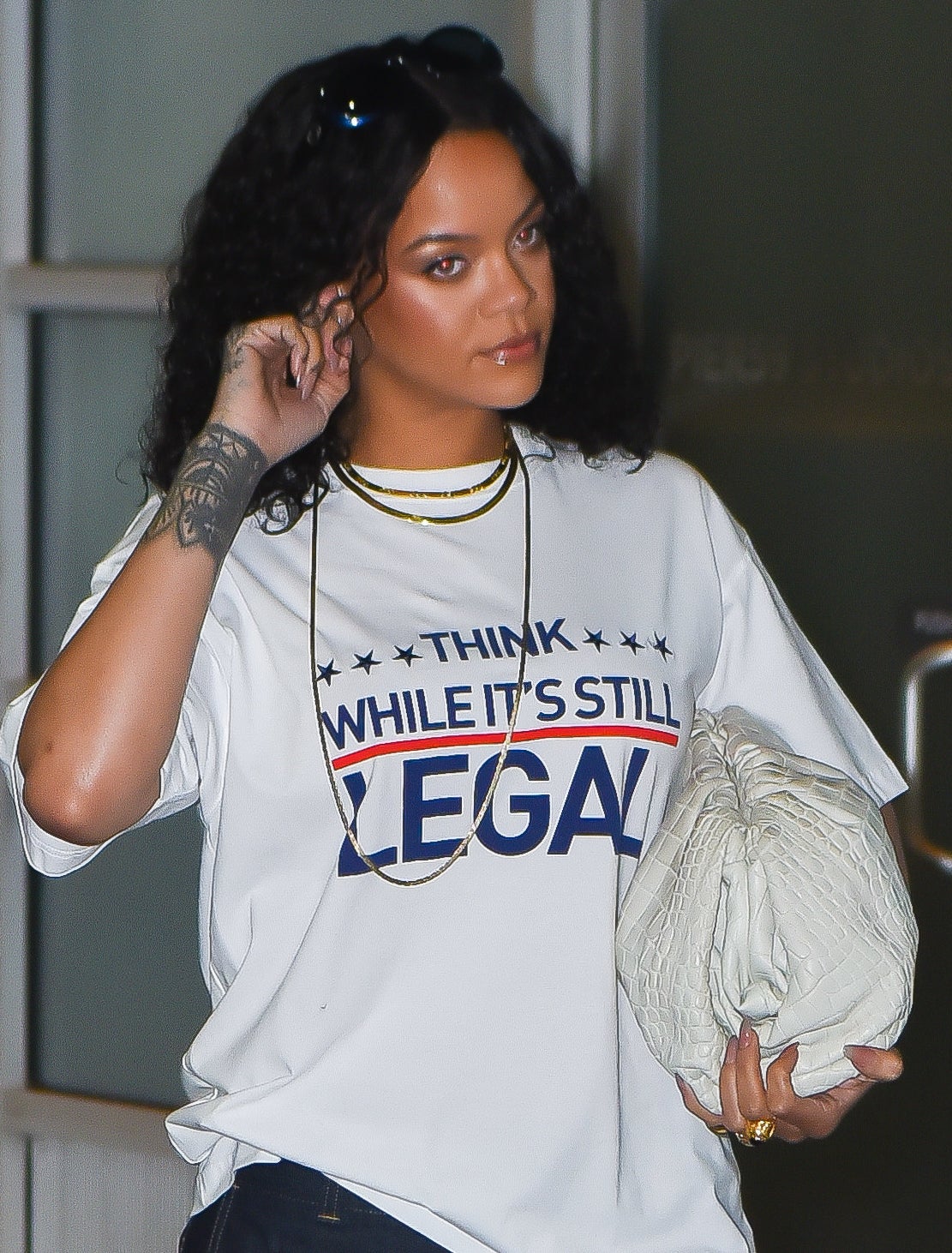 Rihanna wearing a shirt that says &quot;think while it&#x27;s still legal&quot;