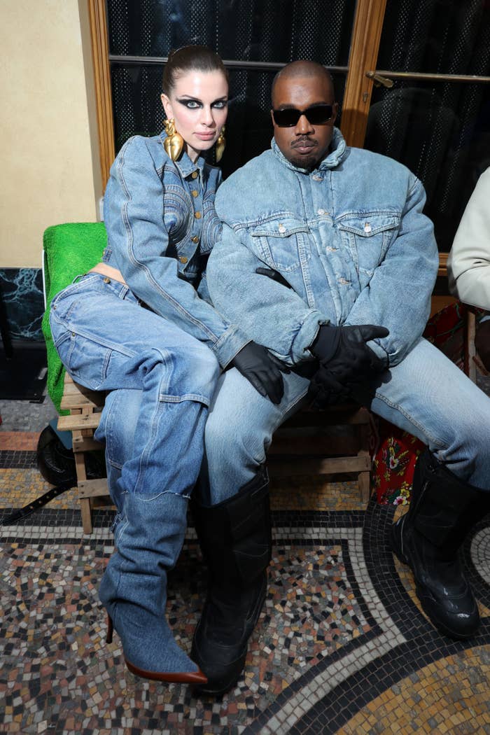 Julia clutches Kanye as they sit next to each other while they wear all denim outfits