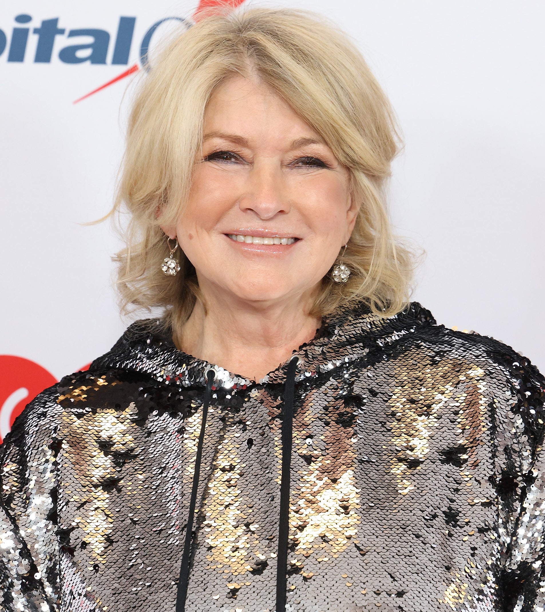 Martha Stewart smiling in an entirely sequined sweatshirt