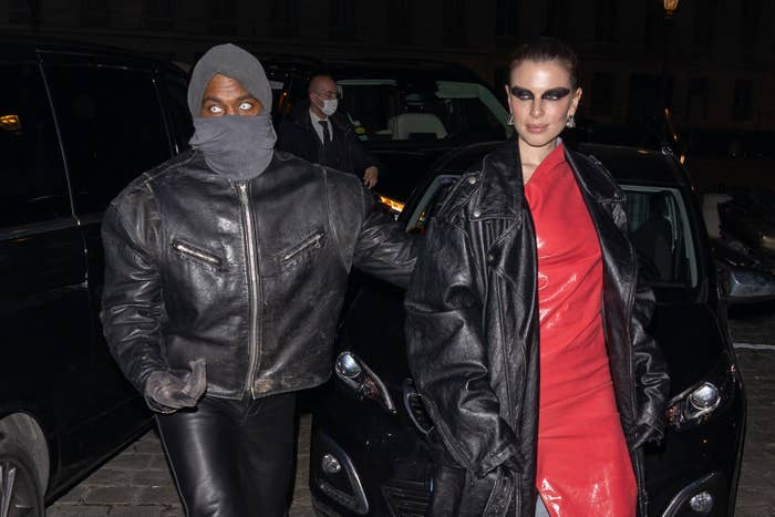 Kanye and Julia Fox walk outside while wearing leather