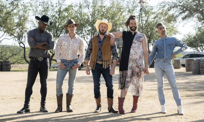 The cast of Queer Eye standing at a ranch