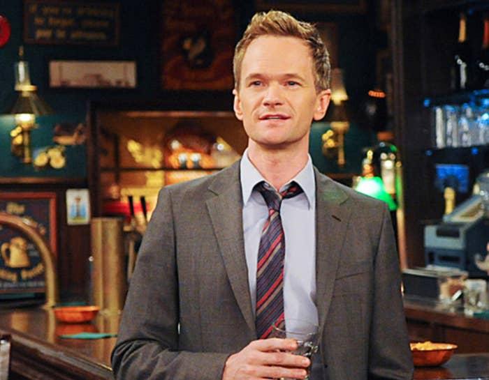 Barney stands in a bar