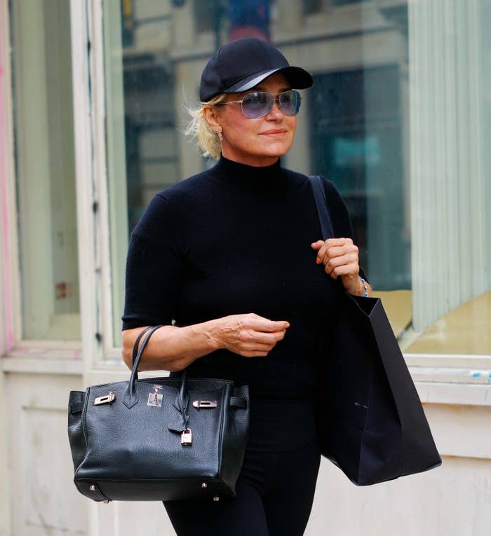 Yolanda Hadid walks down the street while carrying a bag