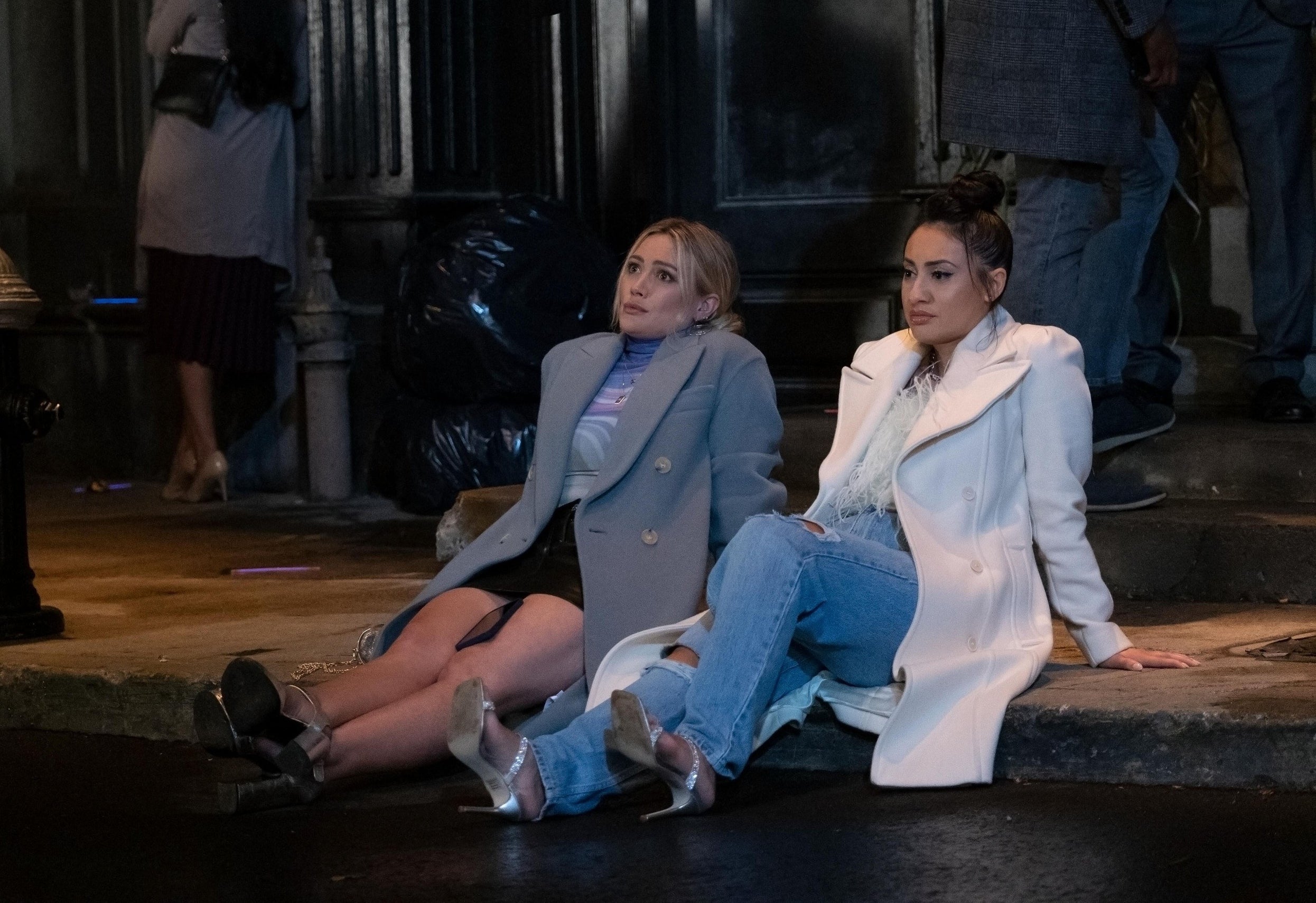 Hilarys&#x27; character and Valentina look glum while sitting on the curb