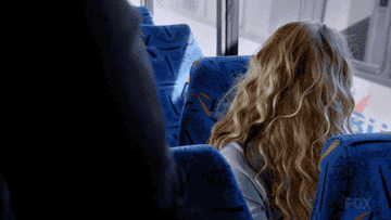 Rosa in blonde hair sitting in the bus