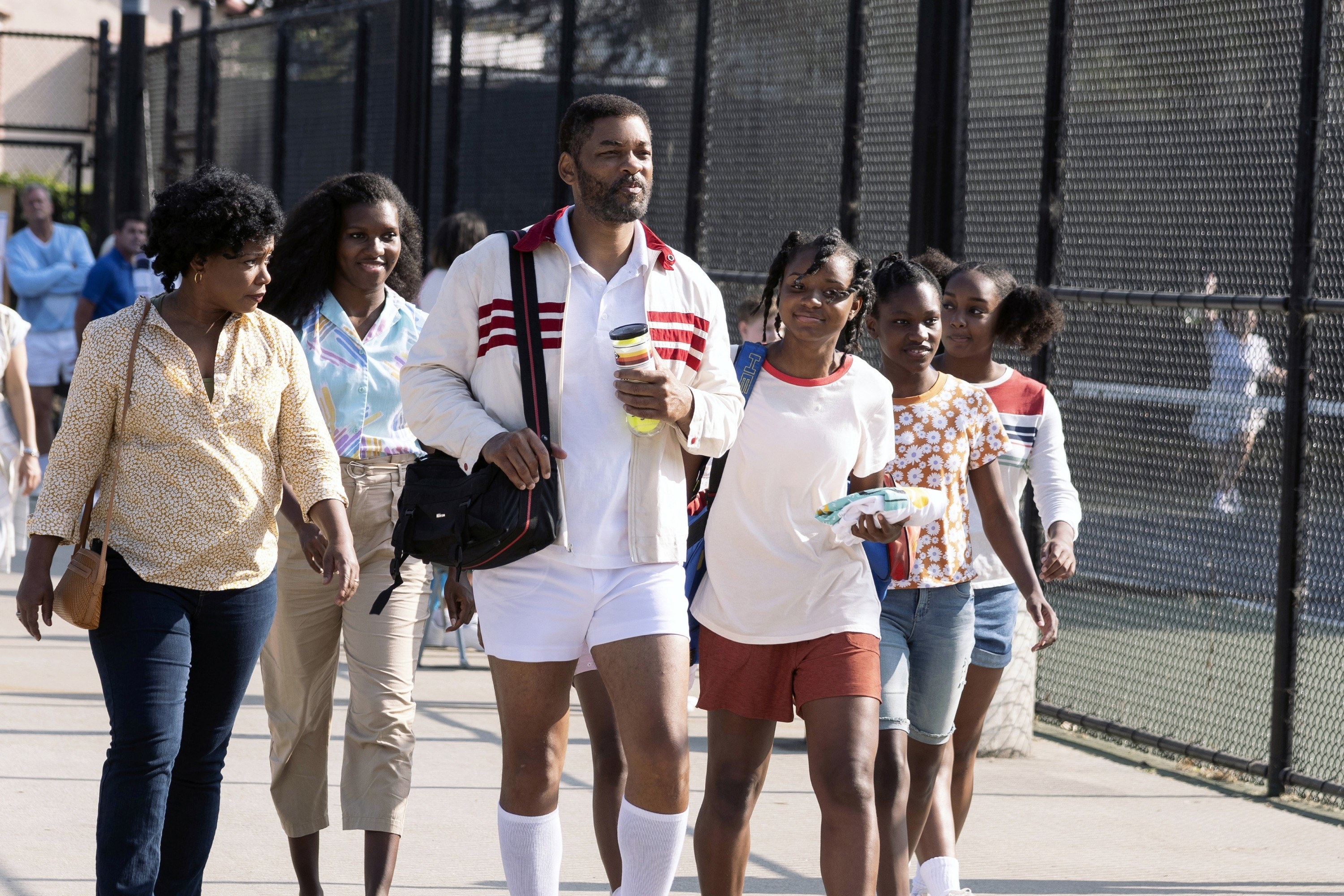 Richard walks with his family outside the tennis courts