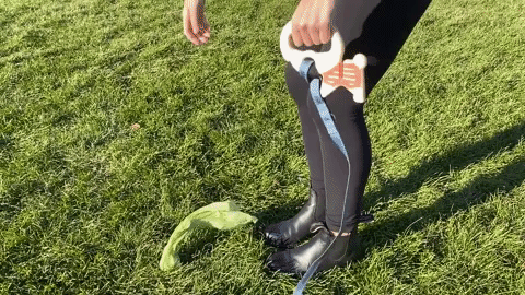 gif of someone picking up a bag of dog poop and wrapping the bag around the leash holder