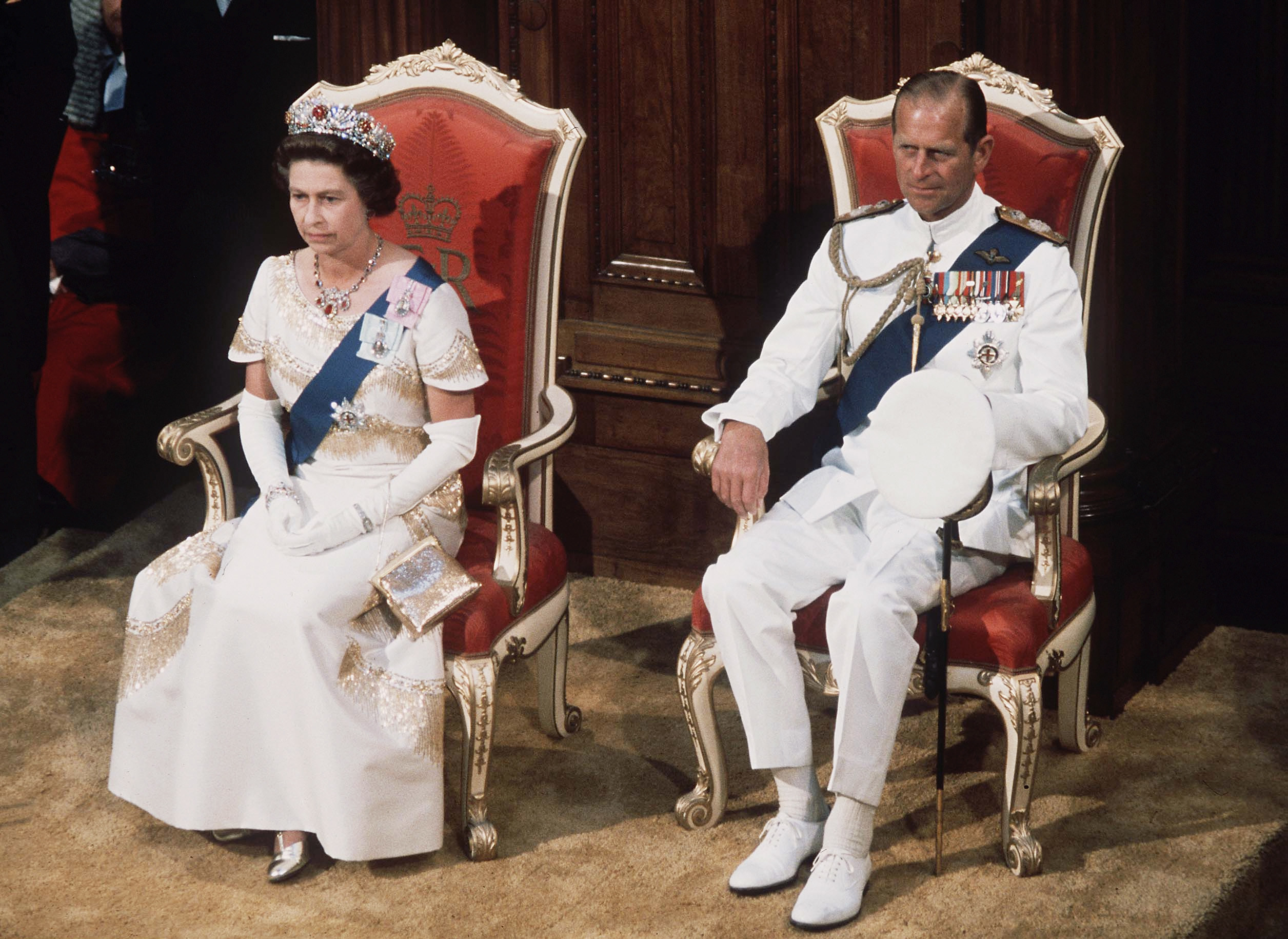 Queen Elizabeth II  and prince philip in regalia on chairs