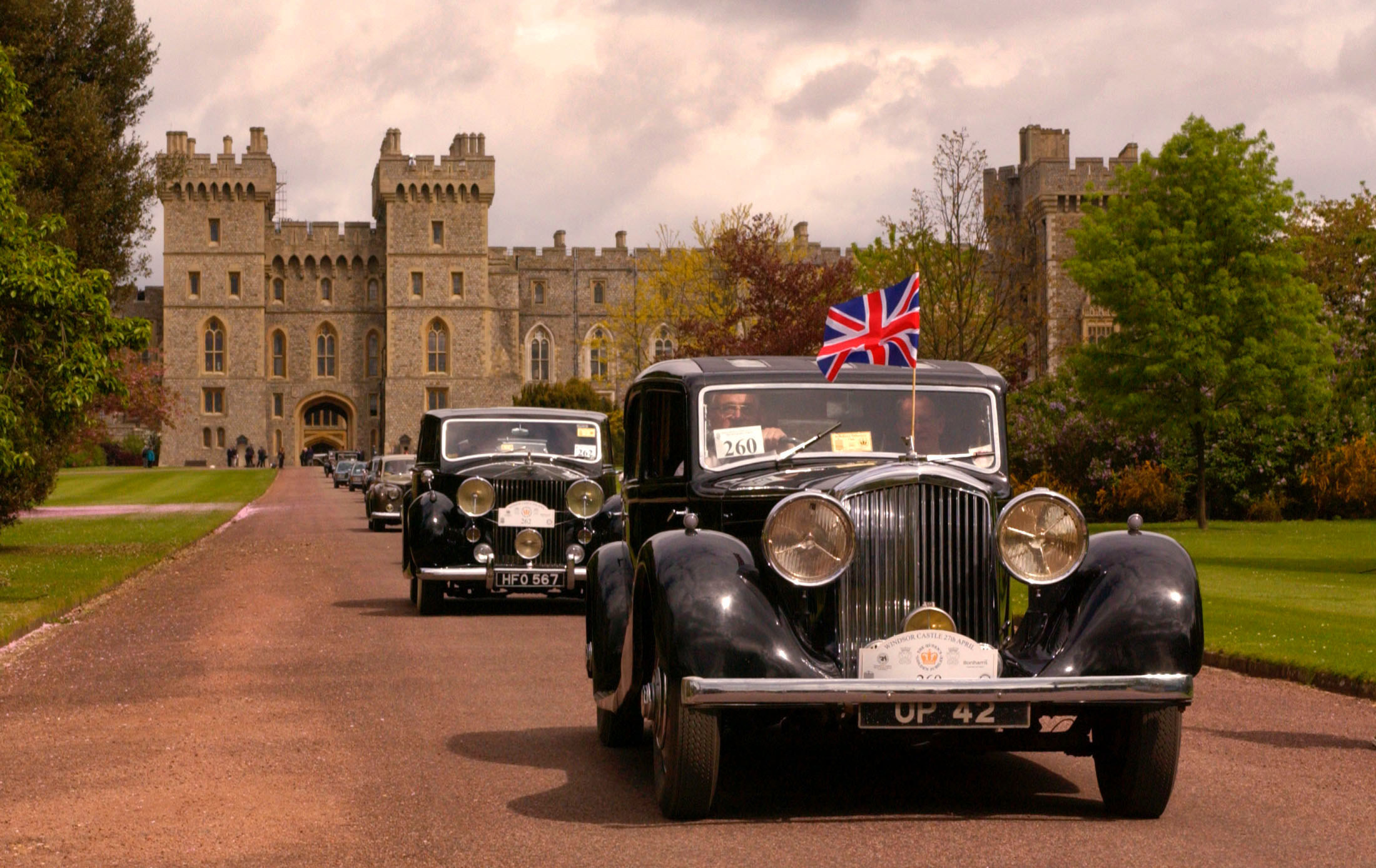 a line of cars driving in front of windsor castle