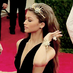 GIF woman fixing hair on red carpet