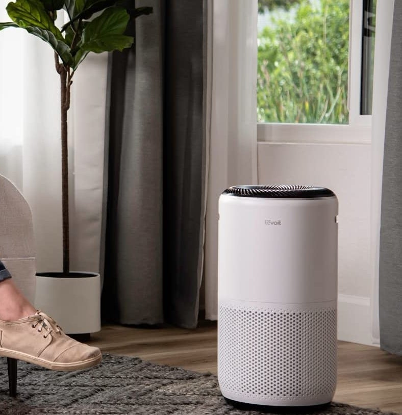 An air purifier on a wooden floor in a living room