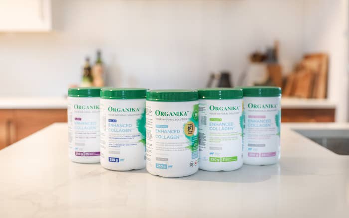 A photo of the line of Organika products on a kitchen counter. There are five bottles.