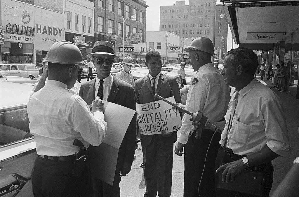 Deputy Chief JL Ray (right) arrests Roy Wilkins (left), Executive Secretary of the NAACP, and Medgar Evers.